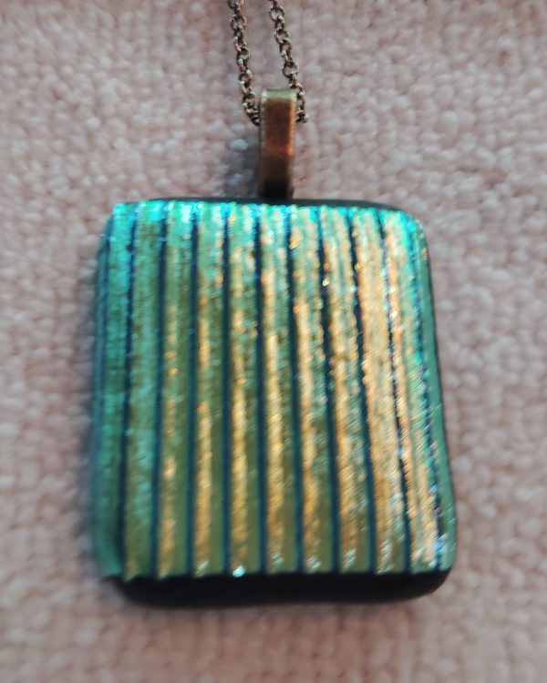 Rectangular glass pendant with vertical stripes of teal and gold, bronze chain