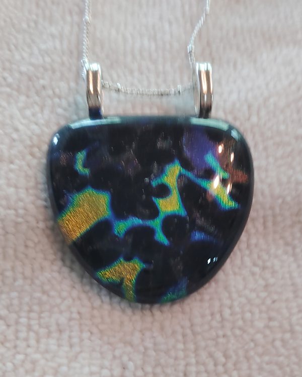 Rounded black glass pendant with gold, teal and violet flashes, two silver bails