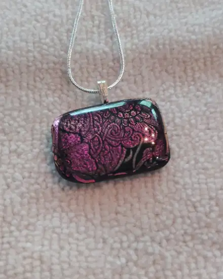 Rectangular glass pendant with a pink and magenta paisley flower pattern, silver chain