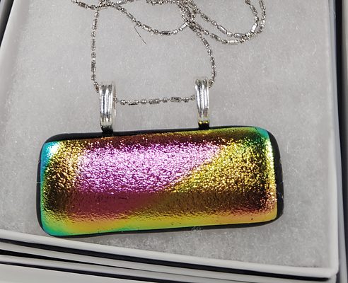 Long rectangular pendant sweeping from green through gold to magenta, on a silver chain